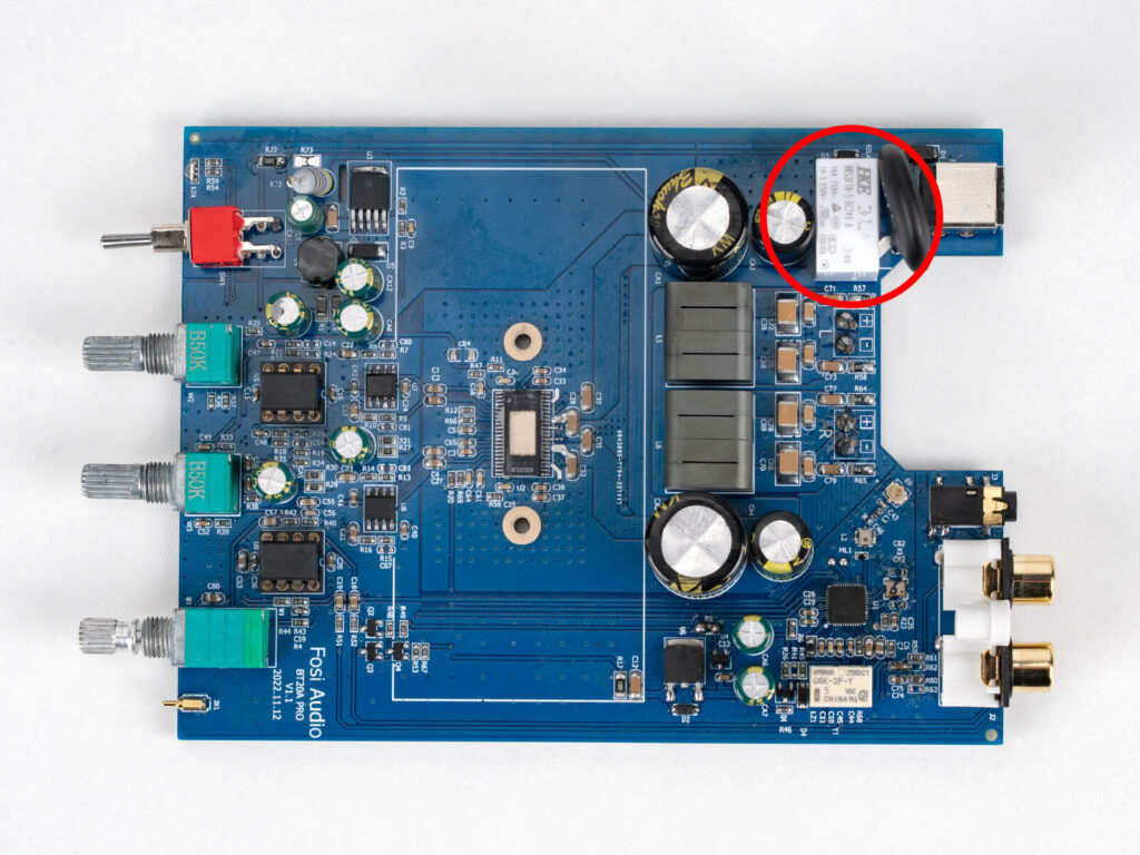 A blue circuit board with many small componentsDescription automatically generated